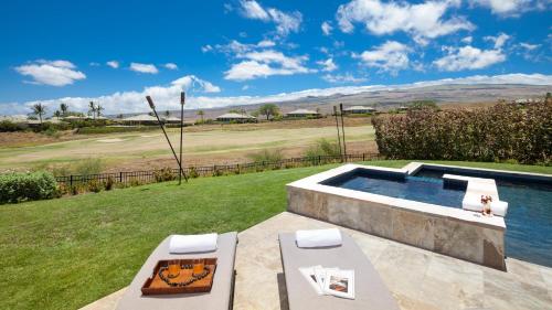 a backyard with a swimming pool and a golf course at ❤PiH❤MAUNA KEA DREAM We ︎ Families Private Heated PoolSpa Stunning Views in Hapuna Beach