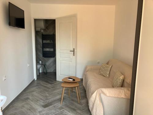 a living room with a couch and a table at Villa Thyziri in Roquefort-les-Pins
