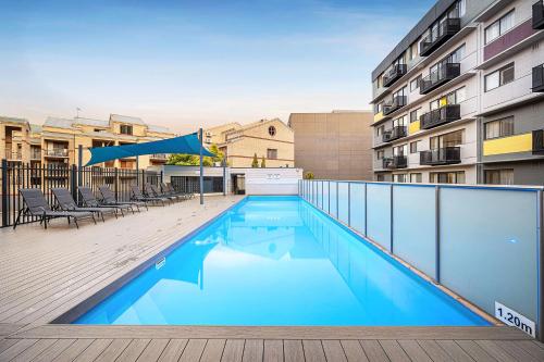 a swimming pool on a balcony of a building at Bespoke & Connected A Sepal Stay in Perth