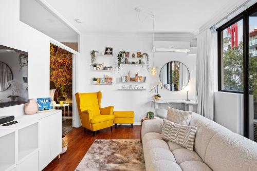 a living room with a couch and a yellow chair at Bespoke & Connected A Sepal Stay in Perth