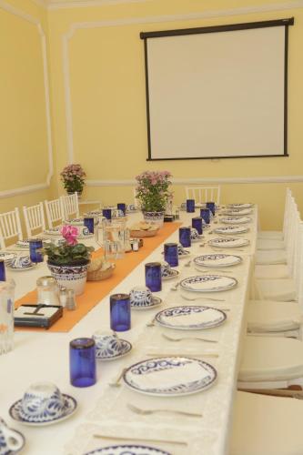 a long table with blue and white plates on it at Hotel Casa Gonzalez in Mexico City