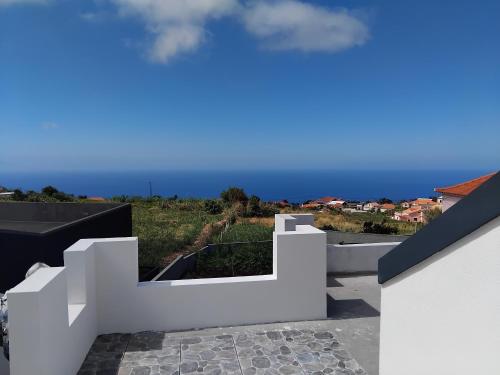 a white house with a view of the ocean at MM House in Bicas
