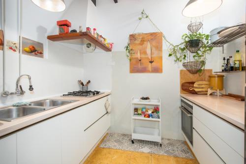 a kitchen with white counters and a sink at Ca Na Mon in Ses Salines