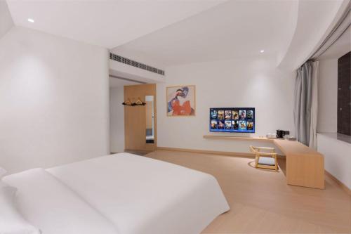 Ένα ή περισσότερα κρεβάτια σε δωμάτιο στο Sanyuan Hotel-Chongqing Jiefangbei Hongyadong
