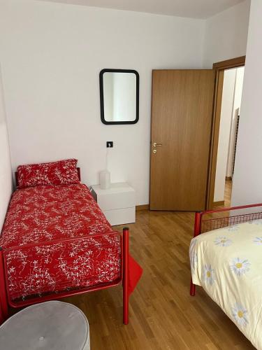 a bedroom with a red bed and a mirror at Poma Luxury 1 Piano in Borno
