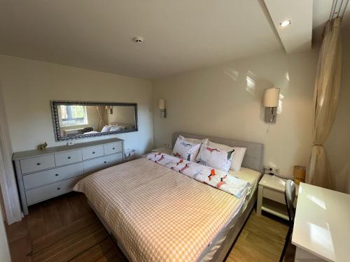 a small bedroom with a bed and a mirror at Chamkoria Forest View & Spa Apartment in Borovets