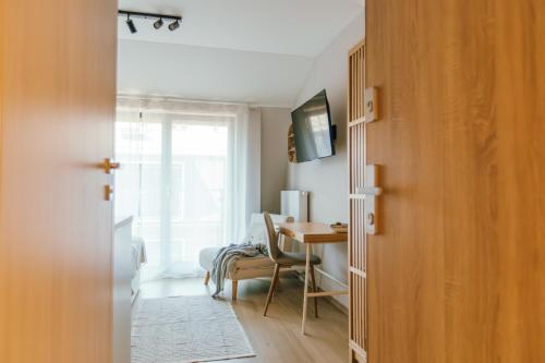 a room with a desk and a table with a chair at Kątowa Studio - Sauna, AC, balcony in Krakow