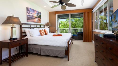 a bedroom with a bed and a dresser and a window at SUMMER BREEZE Sunny 2BR Kulalani Home Next To Community Pool in Waikoloa