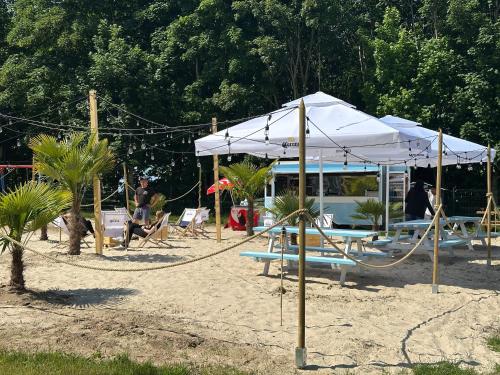 a beach with a swing set and a tent at Villa Hoff Wellness & Spa in Trzęsacz