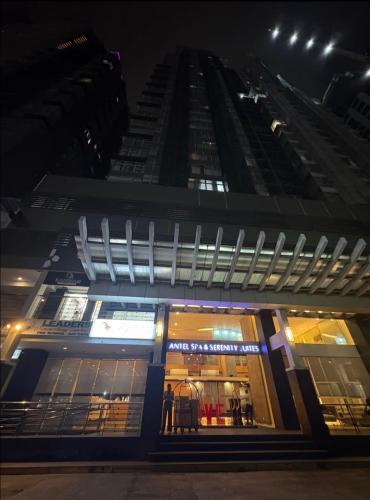a store front of a tall building at night at Folks Hub in Manila