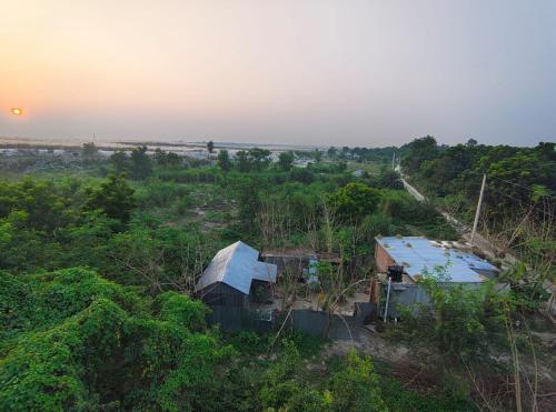 an aerial view of two buildings in a field at Golpo Bari in Kushtia