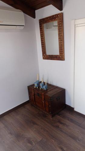 a dresser in a room with a mirror on the wall at Despoina's Beach Escape Above the Sea - Northern Chios in Límnos