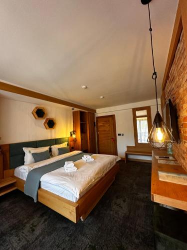 a bedroom with a large bed in a room at Forest Green & Spa in Gura Humorului
