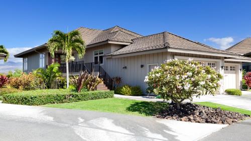 a house with a tree in front of it at SAND CASTLE Modern KaMilo 4BR Home with Ocean Views Bikes in Waikoloa