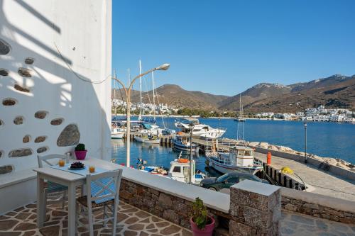 a balcony with a table and boats in a marina at Nicolas House 3 in Rakhídhion