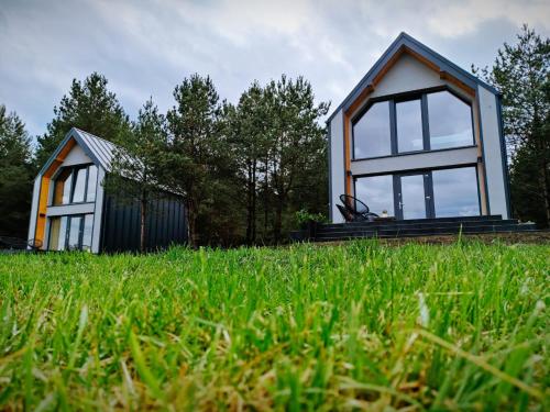 a small house on top of a grass field at Przystań Szwecja in Szwecja