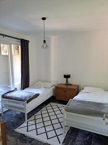 a bedroom with two beds and a window at TriM Apartments in Travnik