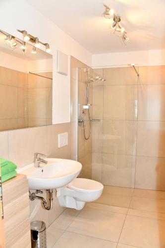 a bathroom with a toilet sink and a shower at Botenhof - Urlaub auf dem Bauernhof - Agriturismo in Sarntal