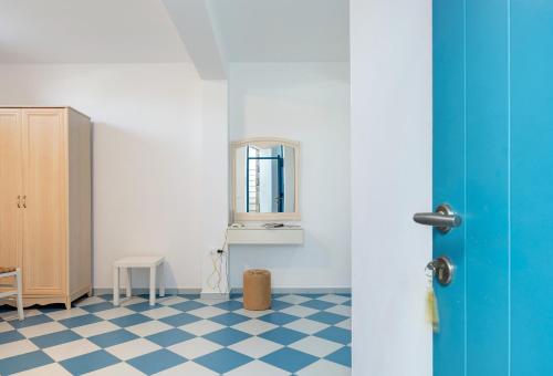 a room with a blue door and a checkered floor at Nicolas House 3 in Rakhídhion