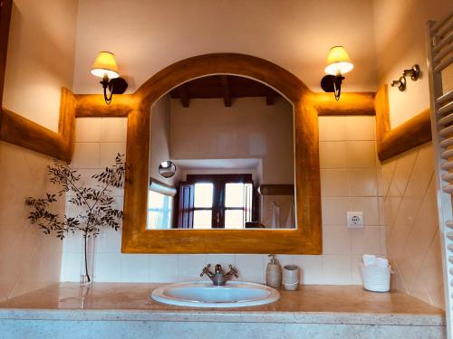 a bathroom with a sink and a mirror at Casal da Serrana in Óbidos