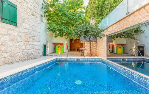 a swimming pool in the middle of a building at MSV Modern Stone Villa in Imotski