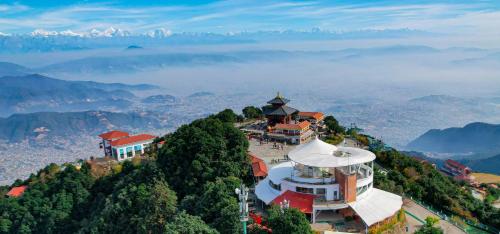 a building on the top of a mountain with a view at Chandragiri Hills Resort Kathmandu-Luxury in the Clouds in Thānkot