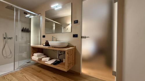 a bathroom with a sink and a shower at A&F LUXURY Rooms Pinzolo in Pinzolo