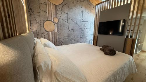 a bedroom with a bed with a towel on it at A&F LUXURY Rooms Pinzolo in Pinzolo