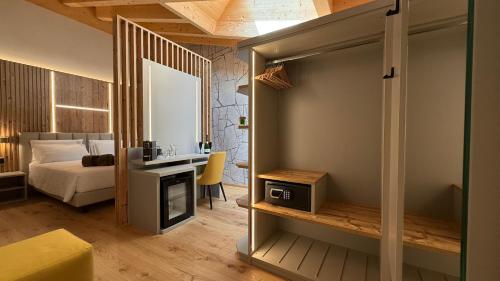 a bedroom with a bed and a desk in a room at A&F LUXURY Rooms Pinzolo in Pinzolo