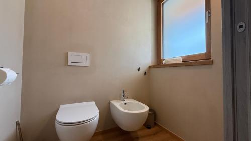 a bathroom with a toilet and a sink at A&F LUXURY Rooms Pinzolo in Pinzolo