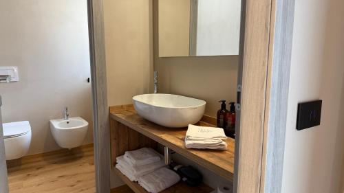 a bathroom with a large bowl sink on a counter at A&F LUXURY Rooms Pinzolo in Pinzolo