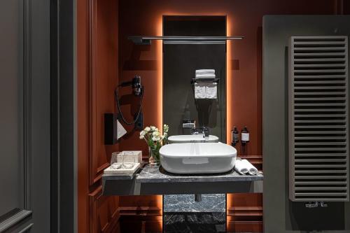 a bathroom with a white sink on a counter at LUBICH Concept Hotel in Lviv