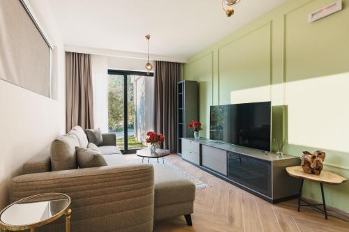 a living room with a couch and a television at CAROLEA VILLAS in Ulcinj
