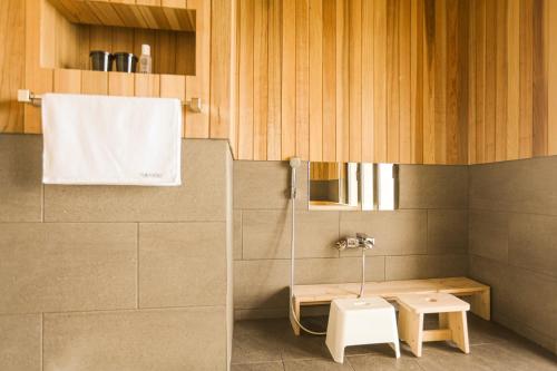a small bathroom with a sink and a toilet at Tomonoya Signature Ryokan Namhae in Namhae