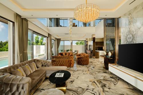 a living room with a couch and a tv at Villa Kalem Uluwatu by Nakula in Uluwatu