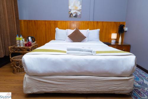 a large white bed with two towels on it at Saanvi Hotel & Restaurant in Kathmandu