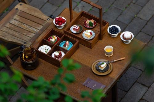 a miniature table with plates of food on it at Lijiang Old Town Anyu hotel in Lijiang
