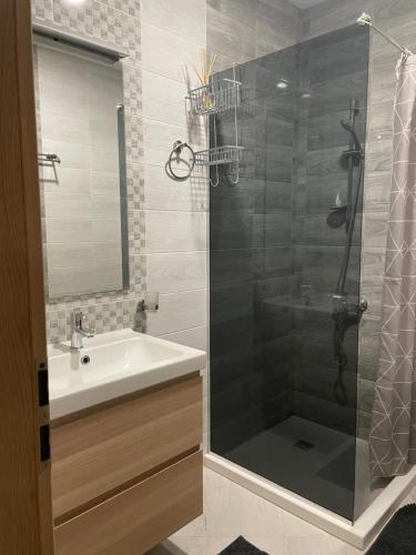 a bathroom with a sink and a glass shower at North Star - sea apartment in Balchik