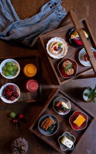 a table with plates of food in a wooden box at Lijiang Old Town Anyu hotel in Lijiang