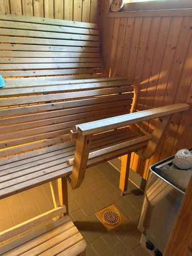 a wooden bench sitting in a sauna at Harmonia2 in Keminmaa