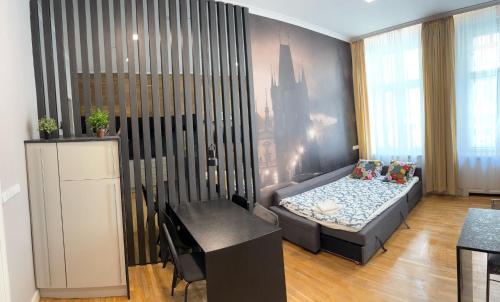 a small room with a bed and a table at Holec Apartments in Prague