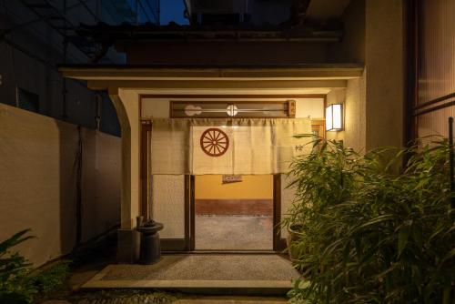 an entrance to a building with a door with a curtain at Ichirin Kanazawa in Kanazawa