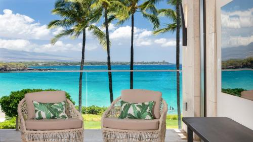 two chairs on a patio with a view of the ocean at ❤PiH❤ Hapuna Surfside Beachfront Steps From Ocean B26 in Hapuna Beach