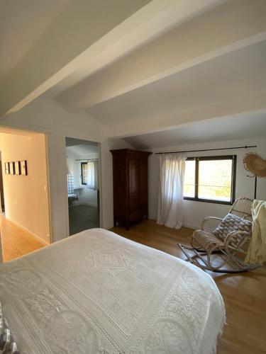 a bedroom with a bed and a chair in it at Chambres d'hote Bergerie A Maredda in Murato