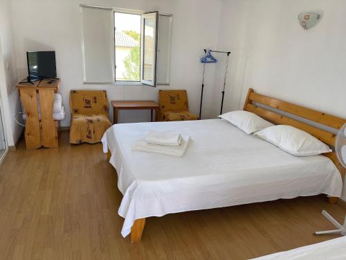 a bedroom with a large white bed and a window at Old School in Vama Veche