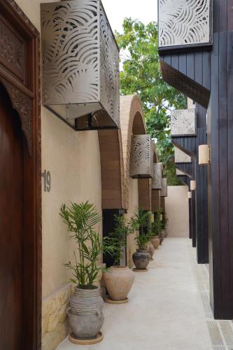 a hallway with potted plants on the side of a building at Sunny Samudra in Uluwatu