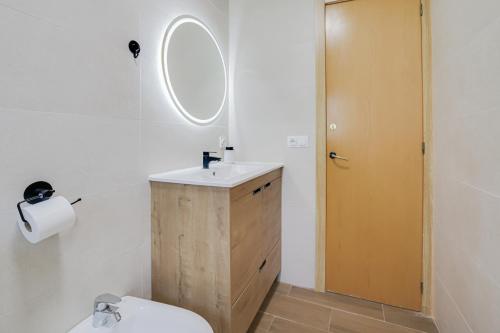 a bathroom with a sink and a toilet and a mirror at Villa Herlinda Costa Brava - With Swimming Pool in Maçanet de la Selva