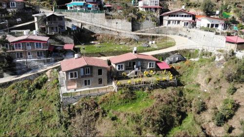 an aerial view of a house on a hill at Indus Valley Homestay in Mukteswar