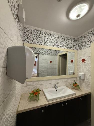 a bathroom with a sink and a mirror at Jacuzzi Escape in Tirana