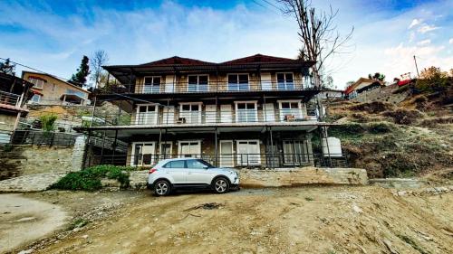 a car parked in front of a house at Indus Valley Homestay in Mukteswar
